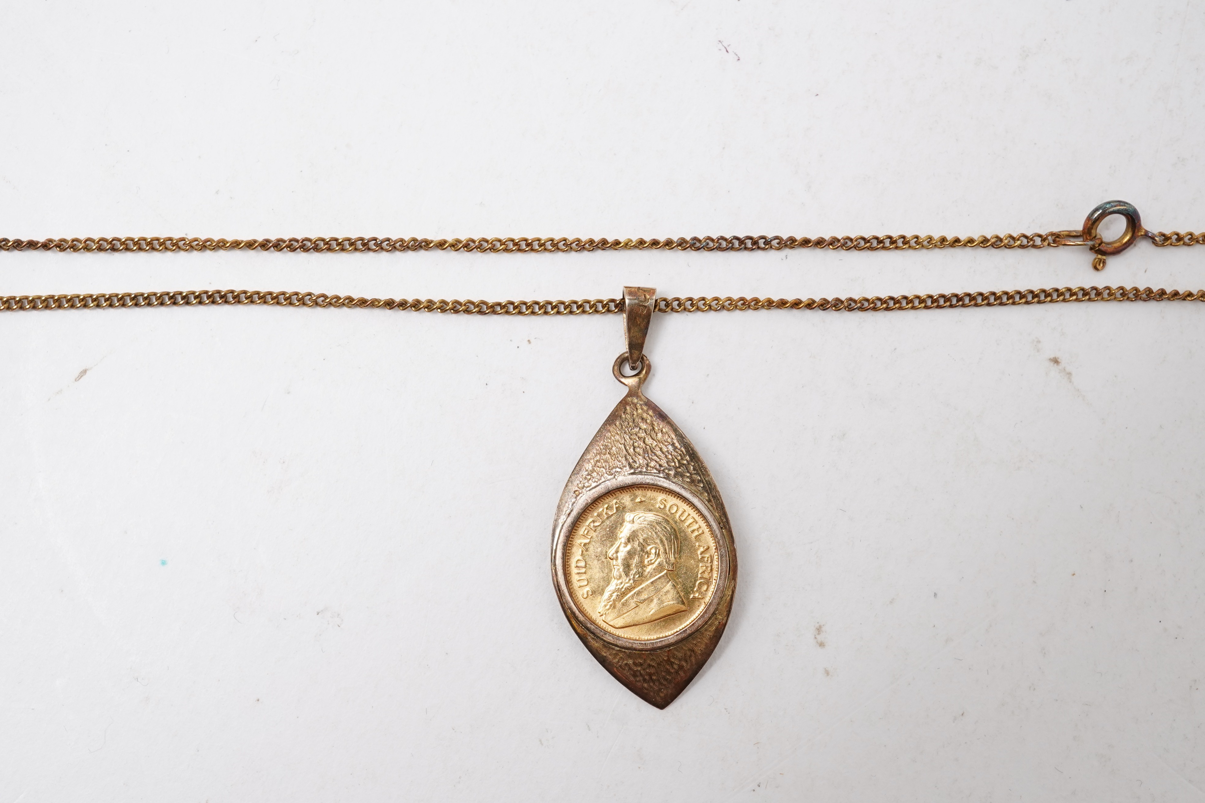 A gold 1/10 Krugerrand coin necklace, circa 1988 and later